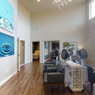 A modern salon interior with stylish decor and hair drying stations.