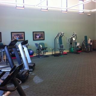 Empty gym with exercise equipment and treadmills.
