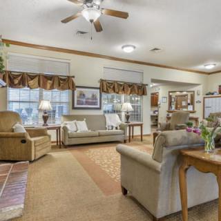 A cozy living room with comfortable seating and traditional decor.