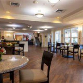 A spacious dining area with tables, chairs, and warm lighting.