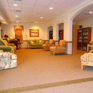 A spacious living room with comfortable seating and elegant decor.