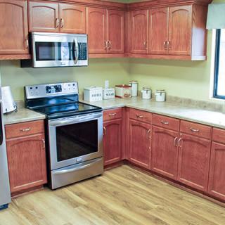 A modern kitchen with stainless steel appliances and wooden cabinets.