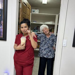 A lighthearted moment captured in an office setting with two individuals, one holding a drink.