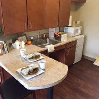 A small kitchen with a dining area set up for two.