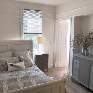 A bright and cozy bedroom with neutral decor.