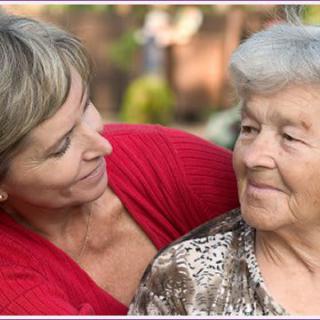 A warm moment between a younger and an older woman, highlighting care and companionship.