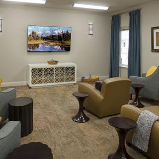 A cozy living room with comfortable seating and a large television.