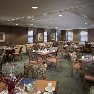 A spacious restaurant dining room with neatly arranged tables and chairs.