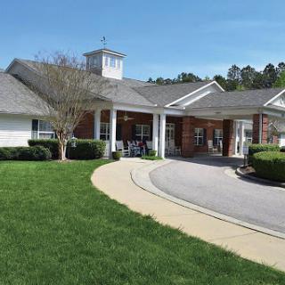 A scenic view of a community care facility on a bright, sunny day.