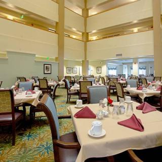 A spacious restaurant dining area with neatly set tables and chairs.