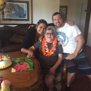 A happy family celebrating a birthday with cake and decorations.