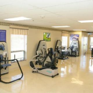 An indoor gym with various fitness equipment and exercise machines.