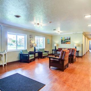 Spacious and well-lit lobby area with comfortable seating and wooden flooring.