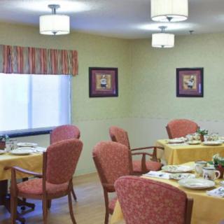 An elegant dining area with neatly arranged tables and chairs.