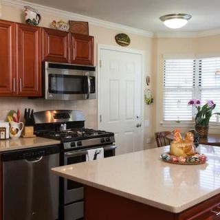 A modern kitchen featuring stainless steel appliances and a central island with decor.