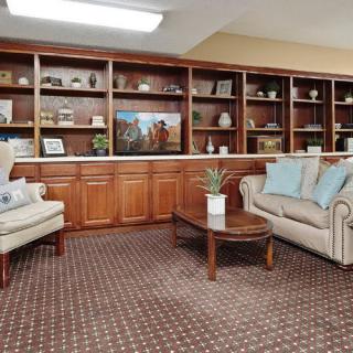 A cozy living room with comfortable seating and bookshelves.