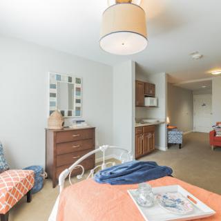 A cozy and modern bedroom featuring a warm color palette, stylish furniture, and ambient lighting.