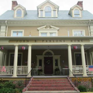 A historic house with a large porch and prominent columns.