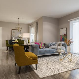 A stylish and modern living room featuring a blue sofa, mustard armchair, and a patterned rug, illuminated by natural light.