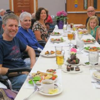 A group of people enjoying a meal together at a dining table.