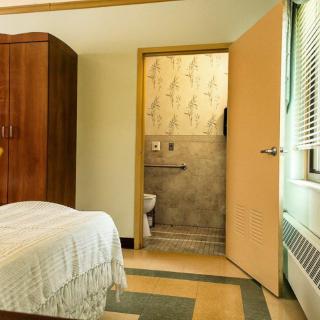 A cozy bedroom with a view into the connected bathroom.