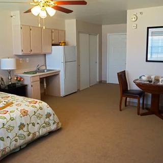 Cozy studio apartment with a kitchenette and dining area.