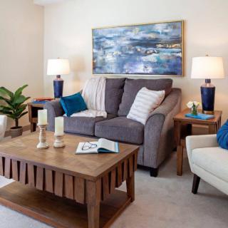 A cozy living room with a comfortable sofa, wooden coffee table, and decorative accents.