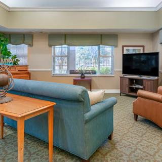 A cozy living room with comfortable seating and a large television.