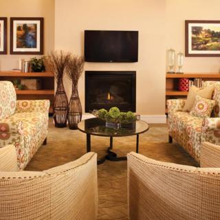 A cozy living room with stylish furniture and a warm fireplace.