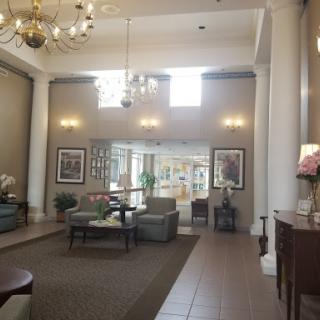 A beautifully designed lobby featuring elegant furniture, a chandelier, and natural light.