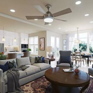 A modern open-concept living room with a connected kitchen and dining area, featuring stylish furnishings and decor.