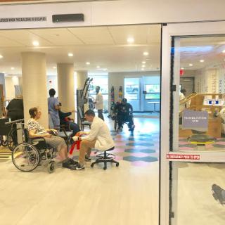 A view of a hospital rehabilitation area with patients receiving care.