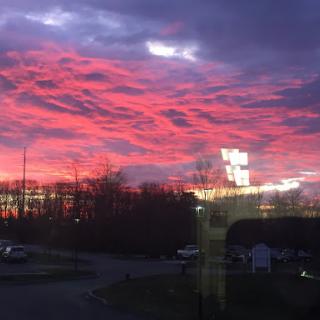 A vibrant sunset paints the sky with shades of pink and purple.