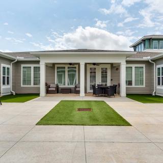 A modern house with a spacious courtyard and well-maintained lawn.