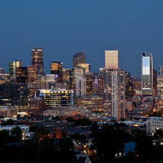 A vibrant skyline of a city illuminated at night.