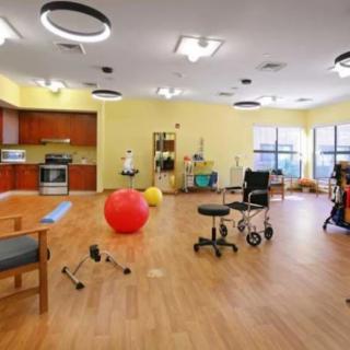 A well-equipped therapy room featuring various exercise and rehabilitation equipment.