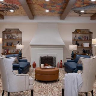 A cozy living room featuring comfortable seating, a fireplace, and elegant decor.