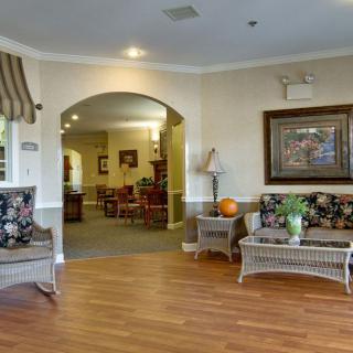 A cozy lobby area with wicker seating and warm decor.