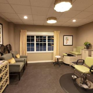 A cozy and well-designed hair salon with comfortable seating and elegant decor.
