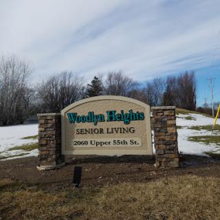 Welcome sign for Brookly Heights Senior Living in a snowy landscape.
