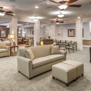 A spacious and elegantly designed living room with comfortable seating and modern lighting.