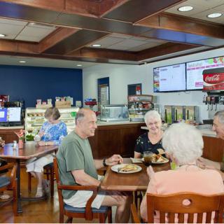 A group of people enjoying a meal together in a cozy cafe setting.