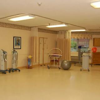 A hospital rehabilitation room with various medical equipment.