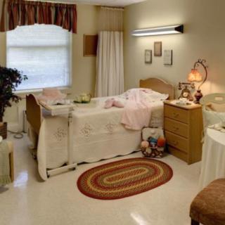 A cozy and well-decorated bedroom with a hospital bed, featuring warm lighting and comfortable furnishings.