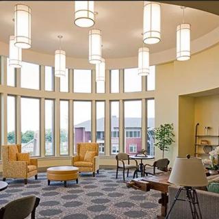A modern lobby with comfortable seating and large windows allowing natural light to fill the space.