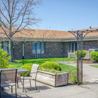 A sunny patio area with outdoor furniture and well-maintained landscaping.
