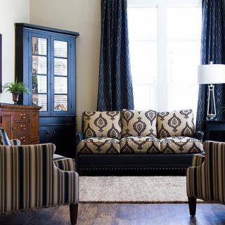 A stylish living room with patterned furniture and elegant decor.