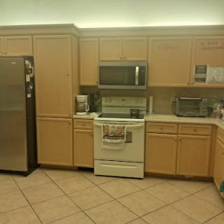 A modern kitchen showcasing essential appliances and cabinetry.