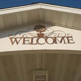 A welcoming sign mounted on the facade of a building.