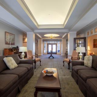 A spacious living room with elegant decor, featuring comfortable sofas and stylish lighting.